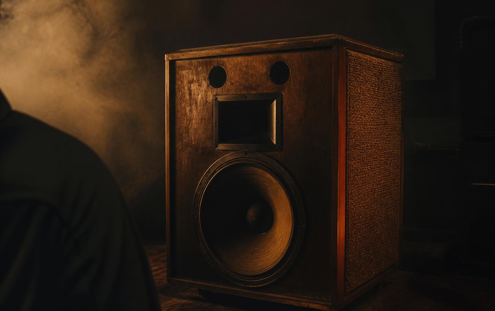 Vintage speaker cabinet in a hazy dark room with warm light